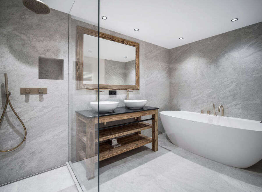 Luxury bathroom with a freestanding bathtub and a walk-in shower, featuring modern fixtures and a rustic wooden vanity.