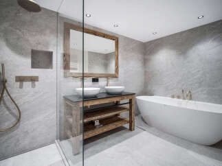 Luxury bathroom with a freestanding bathtub and a walk-in shower, featuring modern fixtures and a rustic wooden vanity.