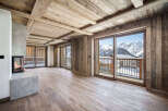 This stunning chalet boasts a spacious open-plan living area with breathtaking mountain views.