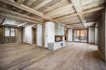 This stunning chalet boasts a spacious open-plan living area with exquisite reclaimed wood flooring and exposed beams.