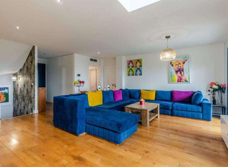 Stunning living room with hardwood floors and a large sectional sofa.