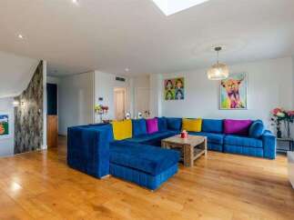 Stunning living room with hardwood floors and a large sectional sofa.