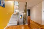 Stunning modern home showcasing a bright, open-concept design with a contemporary staircase and hardwood floors.
