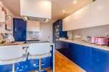 Stunning modern kitchen with sleek blue cabinetry and white countertops.