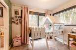 Charming child's bedroom with a unique house-shaped bed, creating a whimsical and playful atmosphere.