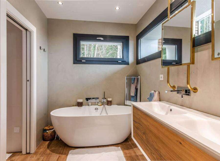Luxurious bathroom with freestanding bathtub and double vanity.
