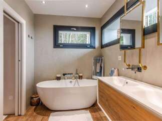 Luxurious bathroom with freestanding bathtub and double vanity.