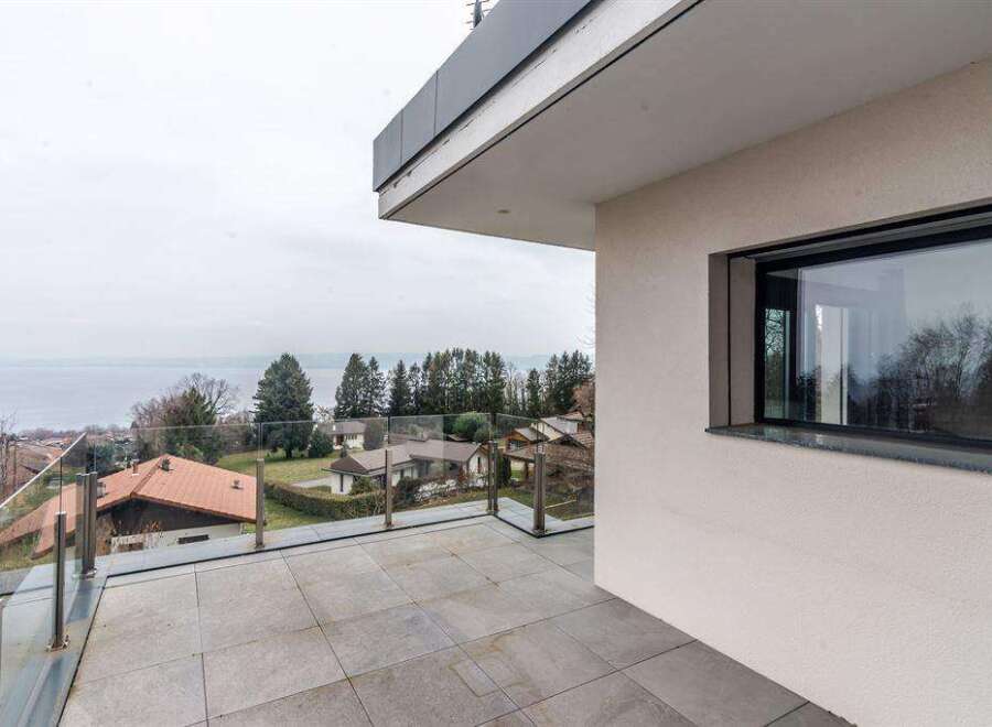 Luxury lake view property with modern design and spacious balcony.
