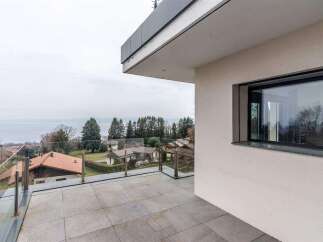 Luxury lake view property with modern design and spacious balcony.