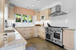 This stunning kitchen boasts a spacious layout with ample counter space and sleek cabinetry.