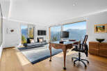 This stunning home office boasts breathtaking panoramic mountain views through expansive windows, creating a serene and inspiring workspace.