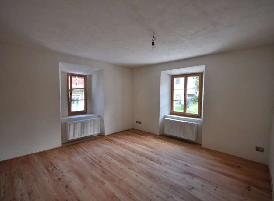 Discover the charm of this inviting room, featuring beautiful wooden floors that add warmth and character.