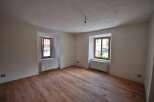 Discover the charm of this inviting room, featuring beautiful wooden floors that add warmth and character.