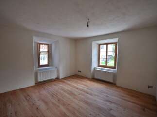 Discover the charm of this inviting room, featuring beautiful wooden floors that add warmth and character.