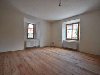 Discover the charm of this inviting room, featuring beautiful wooden floors that add warmth and character.