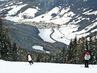 Enjoy breathtaking views of the snow-covered mountains and a charming village nestled in the valley.