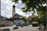 Explore the charming town square featuring a historic church with a distinctive spire.