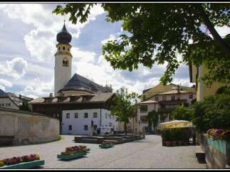 Explore the charming town square featuring a historic church with a distinctive spire.