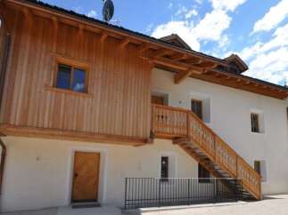 Discover the charm of this stunning property, featuring a unique wooden facade and a beautifully crafted staircase.