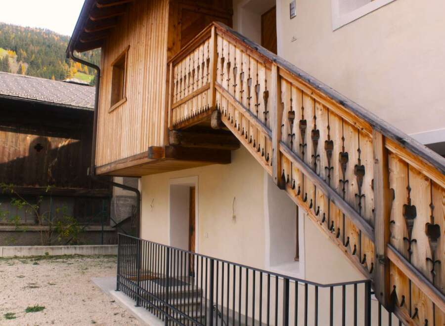 Discover the charm of this unique property featuring a beautifully crafted wooden staircase.