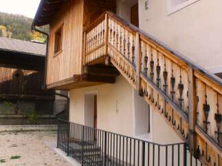 Discover the charm of this unique property featuring a beautifully crafted wooden staircase.