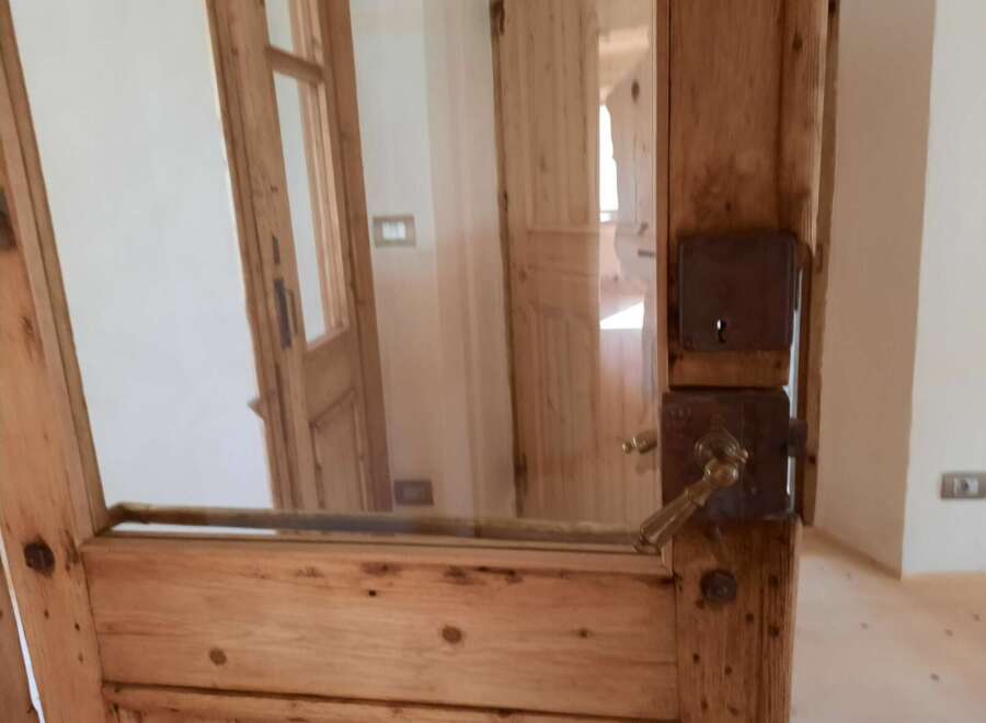 Discover the charm of this property with its unique wooden doors and elegant glass panels.