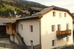 Discover a charming house nestled in a picturesque mountain setting.