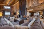 Experience luxury living in this stunning chalet, featuring a grand fireplace and exquisite wooden accents throughout.