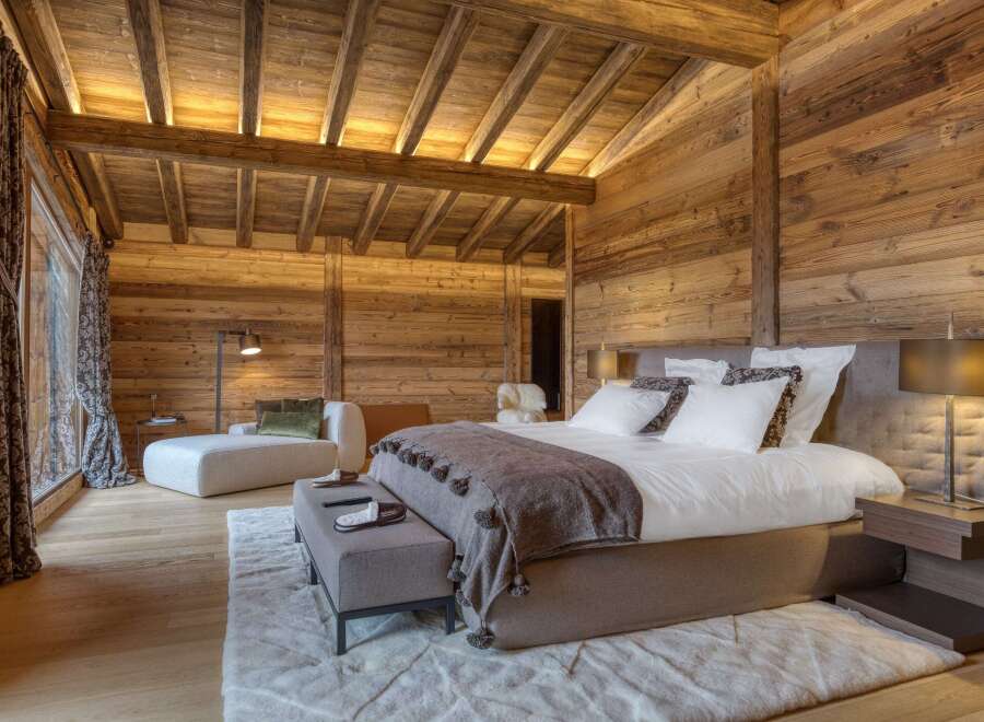 Experience rustic luxury in this stunning wooden bedroom.