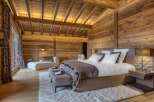 Experience rustic luxury in this stunning wooden bedroom.