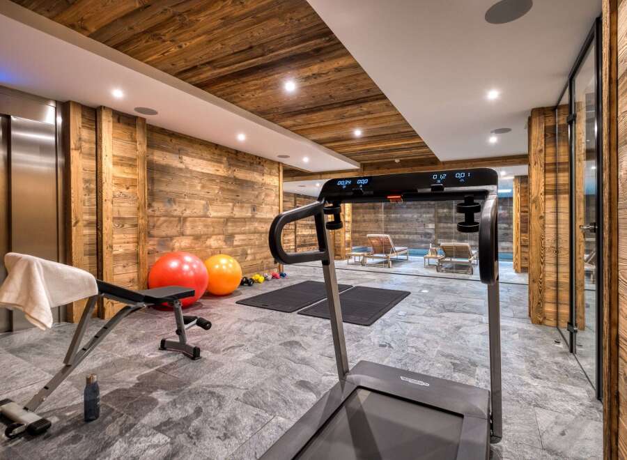 This luxurious gym boasts a stunning wooden interior, creating a warm and inviting atmosphere.