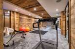 This luxurious gym boasts a stunning wooden interior, creating a warm and inviting atmosphere.