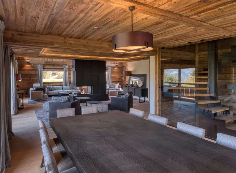 Experience luxury living in this stunning chalet, featuring exquisite wooden interiors and a cozy fireplace.