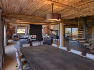 Experience luxury living in this stunning chalet, featuring exquisite wooden interiors and a cozy fireplace.