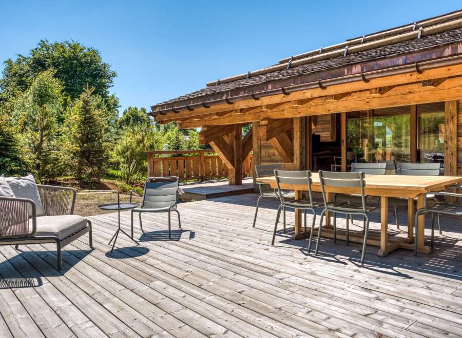 Enjoy the tranquility of this stunning wooden deck, perfect for outdoor gatherings.