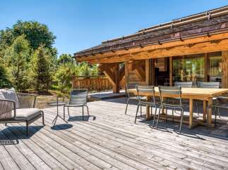 Enjoy the tranquility of this stunning wooden deck, perfect for outdoor gatherings.
