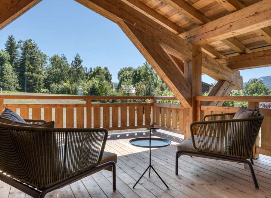 Enjoy the tranquility of this stunning outdoor space, featuring a cozy seating area perfect for relaxation.