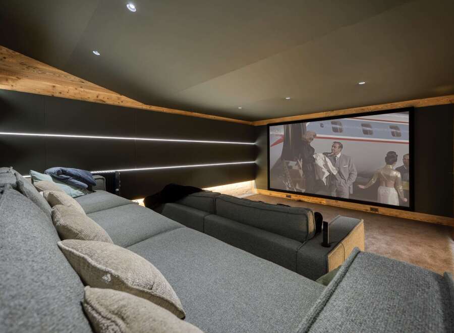 Step into luxury with this stunning home theater! Featuring a large screen, comfortable seating, and ambient lighting, it's the perfect space for movie nights.
