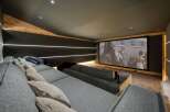 Step into luxury with this stunning home theater! Featuring a large screen, comfortable seating, and ambient lighting, it's the perfect space for movie nights.