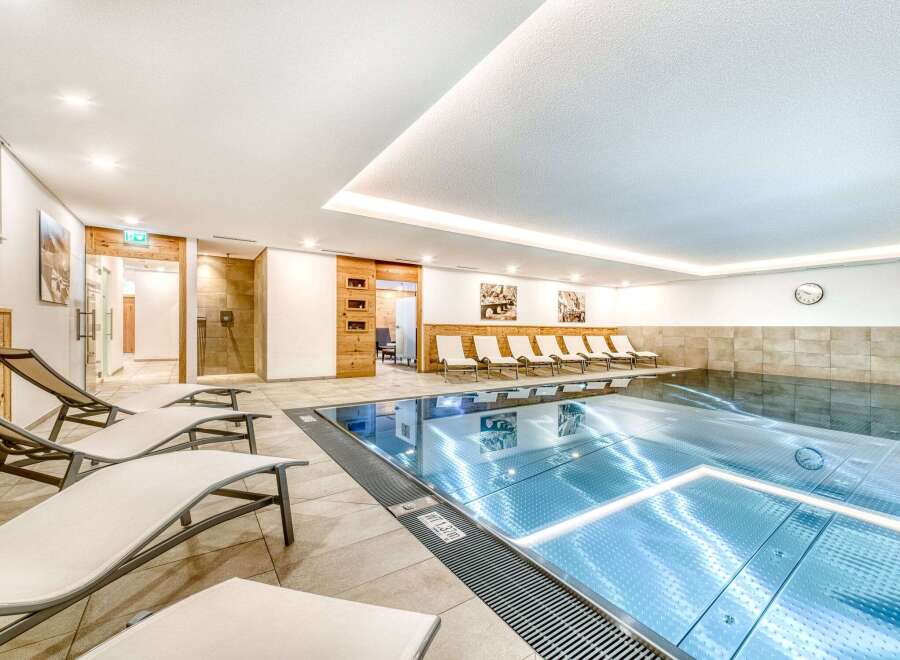 Indulge in a relaxing swim in our pristine indoor pool, surrounded by comfortable lounge chairs perfect for unwinding after a refreshing dip.