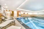 Indulge in a relaxing swim in our pristine indoor pool, surrounded by comfortable lounge chairs perfect for unwinding after a refreshing dip.