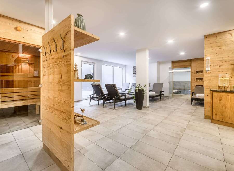 This luxurious spa boasts a stunning sauna with glass doors, offering a relaxing and rejuvenating experience.