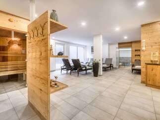 This luxurious spa boasts a stunning sauna with glass doors, offering a relaxing and rejuvenating experience.
