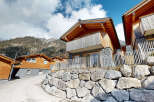 Nestled in a mountainside, this charming chalet boasts stunning views and modern amenities.