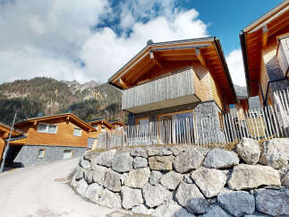Nestled in a mountainside, this charming chalet boasts stunning views and modern amenities.