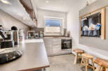 This modern kitchen boasts sleek countertops and ample storage, perfect for culinary enthusiasts.
