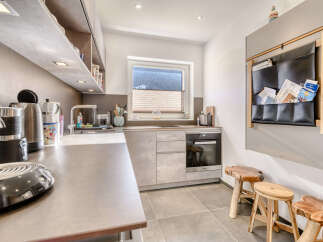 This modern kitchen boasts sleek countertops and ample storage, perfect for culinary enthusiasts.