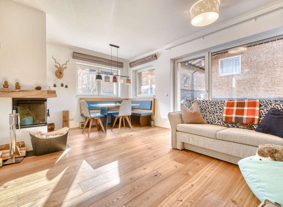Discover the charm of this inviting living space, featuring a cozy fireplace and warm wooden floors.