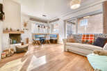 Discover the charm of this inviting living space, featuring a cozy fireplace and warm wooden floors.