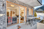 Experience the charm of this stunning property, featuring a beautiful stone exterior and a cozy outdoor patio.